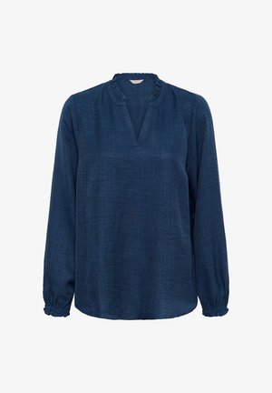 Blouse bleu marine à manches longues, col en V et poignets froncés. Confectionnée dans un tissu texturé avec des détails de volants au niveau du col.