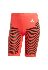 Red athletic shorts made of smooth fabric with a black wavy pattern, featuring a white Adidas logo at the waistband.