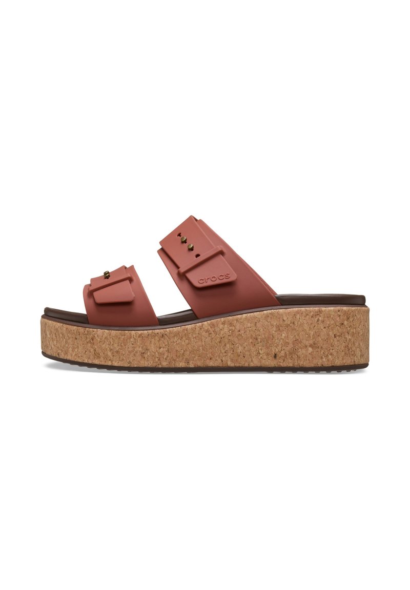 Cork platform sandals in terracotta with adjustable straps and gold studs. Textured sole for grip, featuring Crocs branding on the strap.