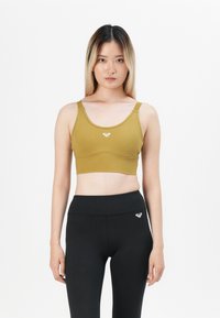 Olive green sports bra with a scoop neckline and elastic band, featuring a small logo on the center front; paired with high-waist black leggings.