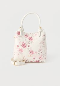 Bolso blanco con estampado floral rosa, asas anudadas, herrajes dorados y correa desmontable, con la marca ALDO en el frente.