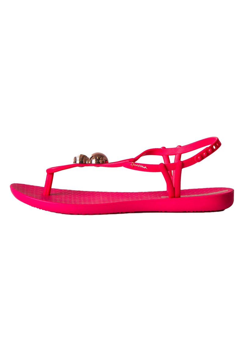 Infradito rosa in gomma con suola testurizzata, dotati di una fascia tra le dita e due palline decorative metalliche sulla parte superiore. Cinghietta regolabile per la caviglia.
