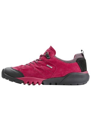 Red suede low-top shoe with a black rubber toe cap, mesh accents, and decorative laces. Features a flexible black rubber sole.