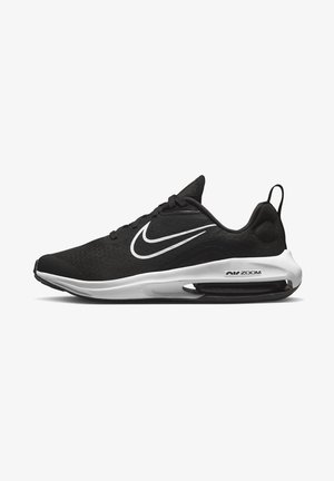 Black Nike sneakers with a mesh upper, white accents, a rounded toe, and a visible air cushioning unit in the sole.