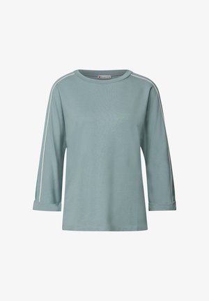 Jasnoniebieska koszula z długim rękawem, z białymi lamówkami na rękawach i podwiniętymi mankietami, z okrągłym dekoltem i luźnym krojem.