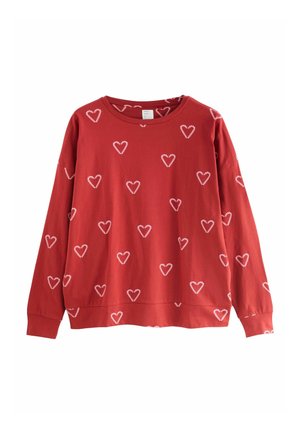 Roter Sweatshirt mit rundem Ausschnitt, langen Ärmeln und einem ganzflächigen weißen Herzmotiv. Hergestellt aus weichem Baumwollmaterial.