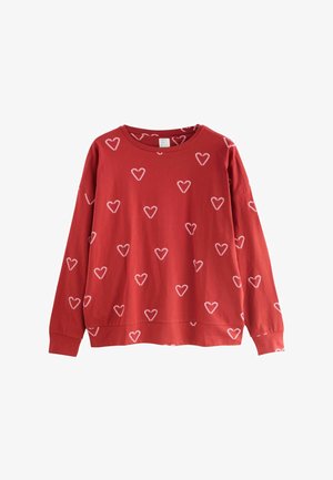Felpa rossa con scollo rotondo, maniche lunghe e stampa a cuori bianchi su tutta la superficie. Realizzata in morbido materiale di cotone.