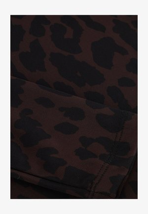 Brown fabric with a black leopard print pattern, featuring a textured surface and visible stitching details.