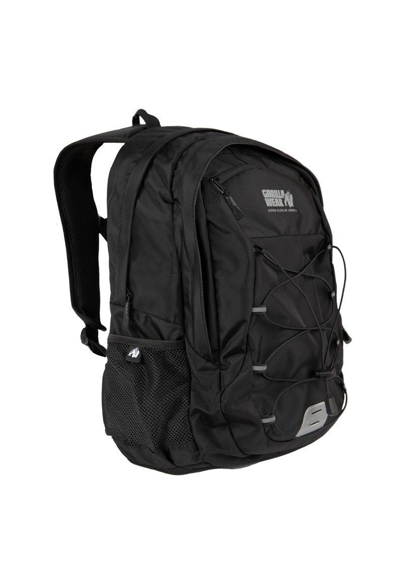 Black fabric backpack with adjustable shoulder straps, front zipper pocket, mesh side pocket, and elastic cord detailing on the front.