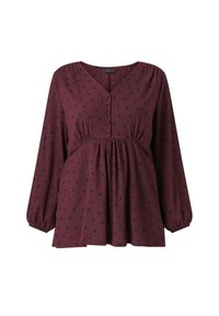 Bordeaux bluse med lange, puffede ærmer. Har en V-halsudskæring, knaplukning og sort prikmønster. Tekstureret stof med rynket talje.