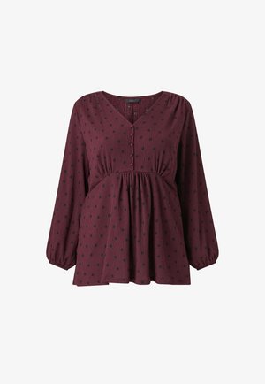 Burgundy blouse with long, puffed sleeves. Features a V-neck, button placket, and black polka dot pattern. Textured fabric with gathered waist.