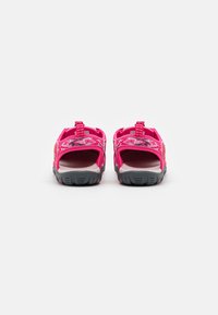 Pink open-toe sandals featuring a patterned upper, adjustable straps, and a textured gray sole. Design emphasizes breathability and comfort.