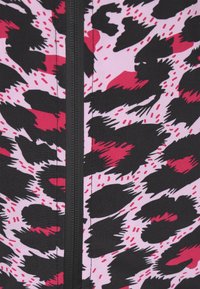 Tessuto con stampa leopardata caratterizzato da audaci motivi neri e rosa intenso su uno sfondo rosa chiaro, con un dettaglio centrale di zip nera.