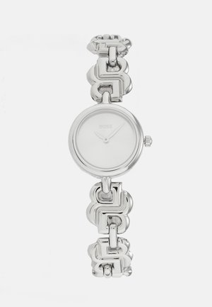 Montre en acier inoxydable argenté dotée d'un boîtier rond, d'un cadran blanc minimaliste et d'un bracelet à maillons épais.