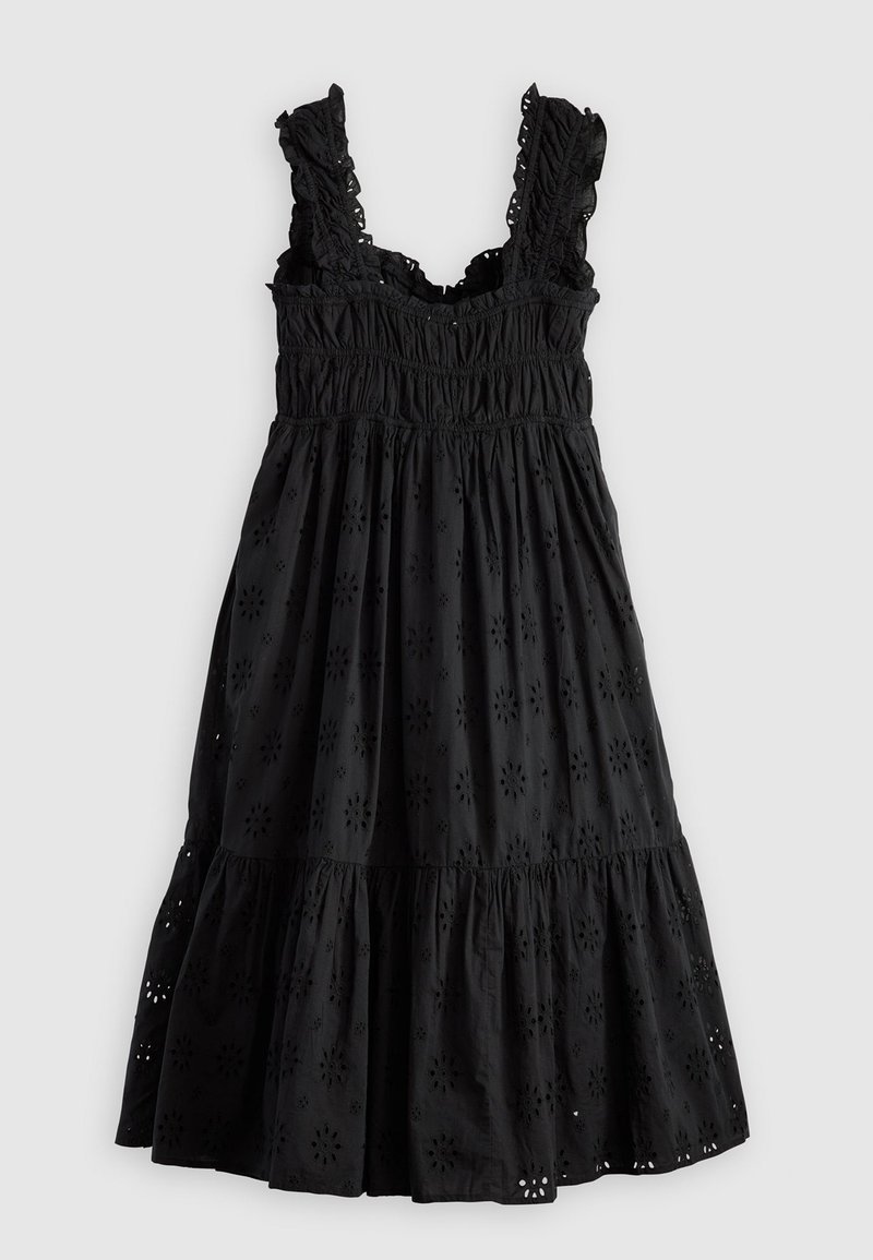 Vestido de algodón negro con corsé fruncido, tirantes con volantes y falda en capas con recortes de ojo de flor.