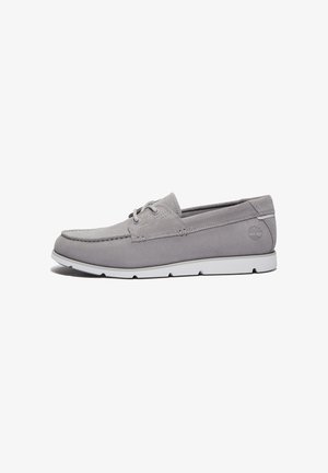 Gray suede boat shoe with a round toe, subtle stitching detail, and white rubber sole. Features lace-up design and logo on side.