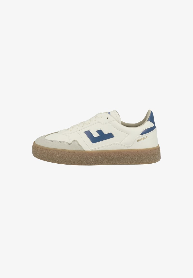 White leather sneaker with navy accents, featuring a textured brown rubber sole and a prominent logo on the side. Laced design.