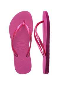 Ζευγάρι ροζ σαγιονάρες Havaianas με υφή στη σόλα, το ένα από πάνω και το άλλο από το πλάι, που δείχνουν μέγεθος 37-38 EU.