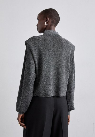 Suéter corto de color gris oscuro con un acabado texturizado y hombros estructurados. Presenta mangas largas y un cuello alto.