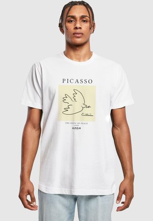 White cotton t-shirt featuring a Picasso design of a dove, with "PICASSO" and "THE DOVE OF PEACE 1949" text in black. Relaxed fit.