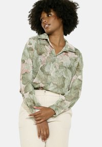 Green and pink floral patterned blouse with a collar, button-down front, and long sleeves, made from lightweight, textured fabric.