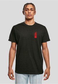 Black cotton t-shirt featuring a red fire extinguisher graphic with text "CRANK PROBLEMS" on the left chest. Short sleeves and round neckline.