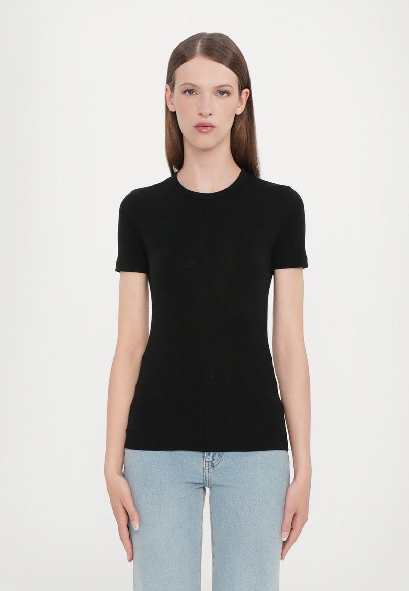 Black short-sleeve t-shirt made of smooth fabric, featuring a round neckline and a fitted silhouette, paired with light blue jeans.