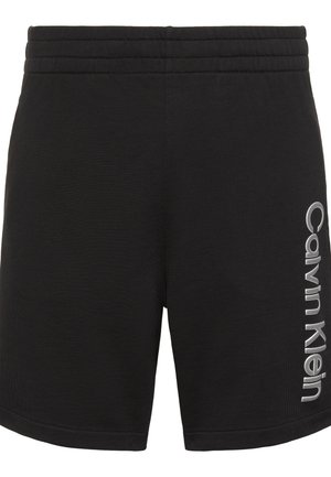 Fekete sportnadrág elasztikus derékrésszel, jobb lábszáron függőlegesen nyomtatott "Calvin Klein" logóval.