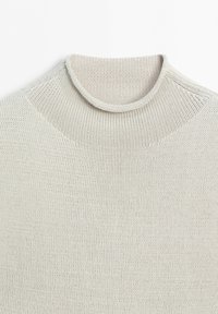 Light grey knitted sweater with a round neckline, showing detailed texture and stitching on a white background.