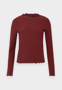 Burgundy pitkähihainen paita, joka on valmistettu ribbiblangasta. Siinä on aaltoileva pääntie ja helma sekä kapea siluetti.