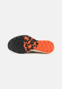 Black and orange textured outsole with a patterned grip and triangular lugs. Features a Continental logo embedded in the design.