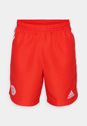 Red athletic shorts with an elastic waistband, featuring white adidas stripes on the sides and a circular Bayern Munich logo on the front.