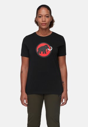 T-shirt en coton noir avec un graphique d'éléphant rouge et noir circulaire et une défense. Manches courtes et coupe classique.