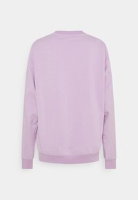 Lilac crewneck sweatshirt, soft cotton blend, ribbed cuffs and hem, and simple design with no visible logos or embellishments.