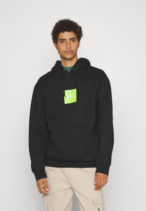 Black hoodie with adjustable drawstring, featuring a green square logo labeled "HUF" at the chest. Textured fabric and front pocket.