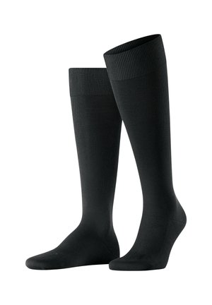 Schwarze knielange Socken mit geripptem Bund und glatter Textur; aus dehnbarem Material für Komfort und Passform hergestellt.
