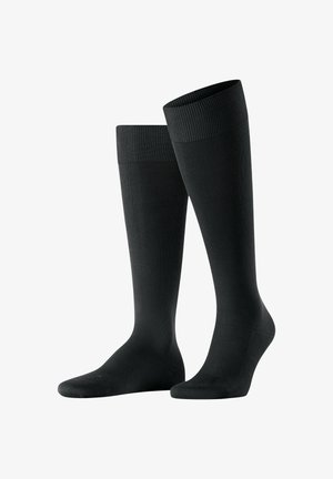 Meias altas pretas até ao joelho com um topo canelado e textura suave; feitas de material elástico para conforto e ajuste.