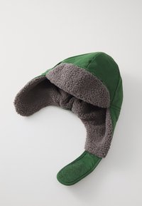 Green aviator-style hat with a gray fleece lining, featuring ear flaps and a textured, adjustable strap. Soft fabric exterior.