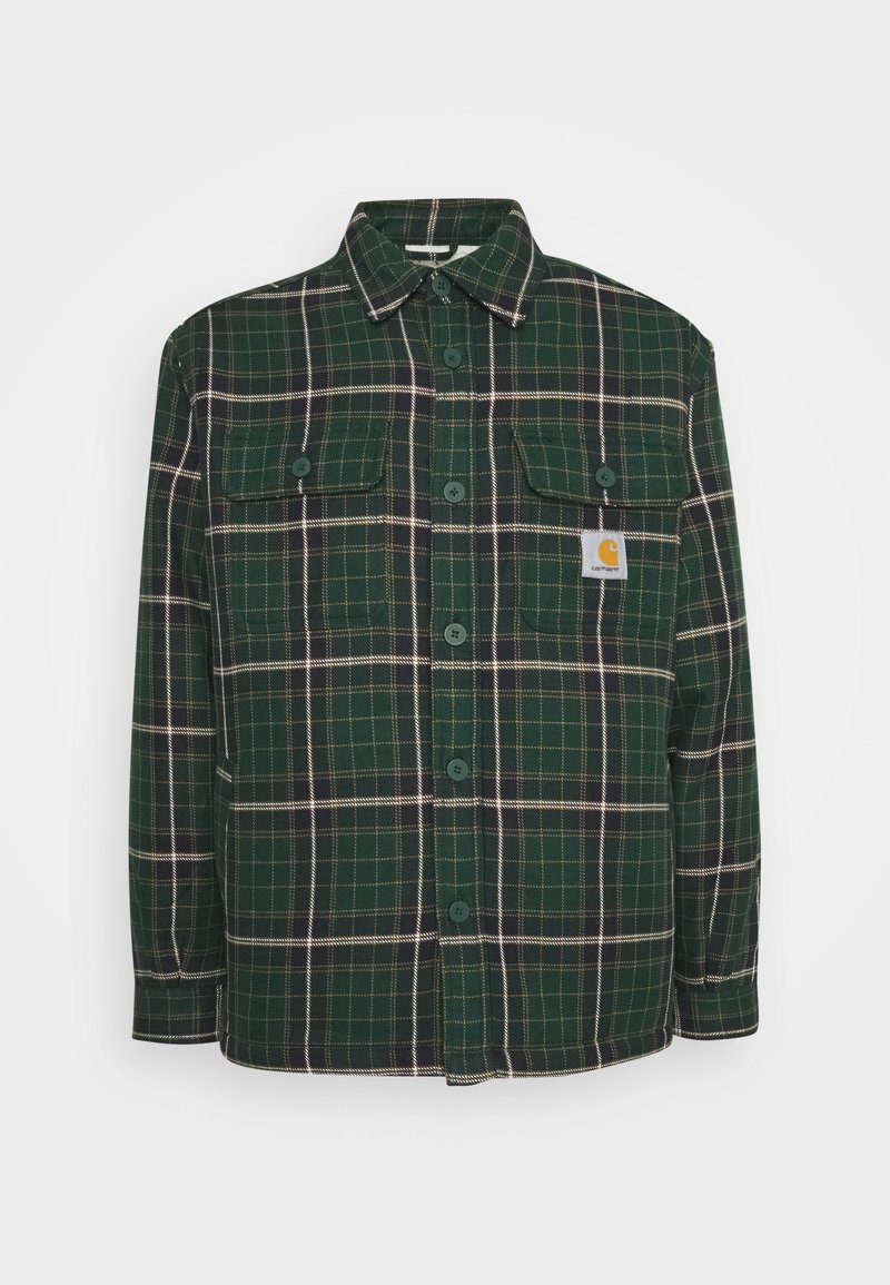 Green plaid flannel shirt with two chest pockets, button closure, and a logo patch. Features a relaxed fit and soft texture.