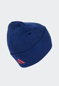 Niebieska dzianinowa czapka beanie o dopasowanym kroju, z prostym wzorem i czerwonym akcentem po boku. Miękka tekstura, okrągły kształt korony.