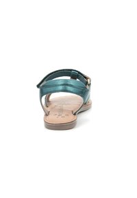 Teal lædersandal med åben bag, to overdele stropper og en polstret indersål med blomstermotiv. Justerbar ankelrem med hardware.