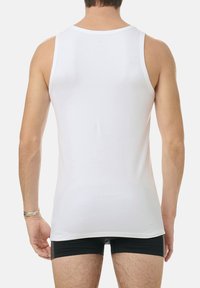 White cotton tank top with a crew neckline. Features a slim fit, smooth texture, and no visible patterns or accents. Back view only.