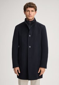 Navyblauer Wollmischgewebe-Mantel mit hohem Kragen, zwei großen vorderen Taschen und drei Knöpfen. Verfügt über ein schlankes, minimalistisches Design.