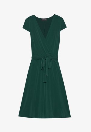 Πράσινο φόρεμα περιτυλίγματος με κοντό μανίκι, V-λαιμό, ζώνη στη μέση και φουσκωτή φούστα. Φτιαγμένο από απαλό, λείο ύφασμα σε ενιαία απόχρωση χωρίς σχέδια.