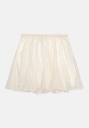 Gaišs ivorijs tilla svārku ar vairākiem līmeņiem, ar elastīgu jostasvietu un rotāts ar smalkiem spīdīgo punktu akcentiem visā virsmā.