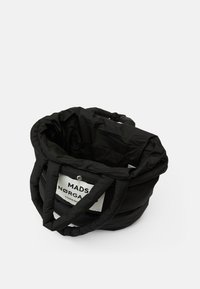 Μαύρη αποθηκευτική τσάντα με επένδυση, που διαθέτει δύο χοντρές λαβές, στρογγυλό σχήμα και μια προεξέχουσα ετικέτα με κείμενο από τη μία πλευρά.