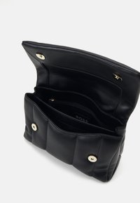 Black leather handbag with a quilted design, featuring a lined interior, zip pocket, and two gold-tone snap closures.