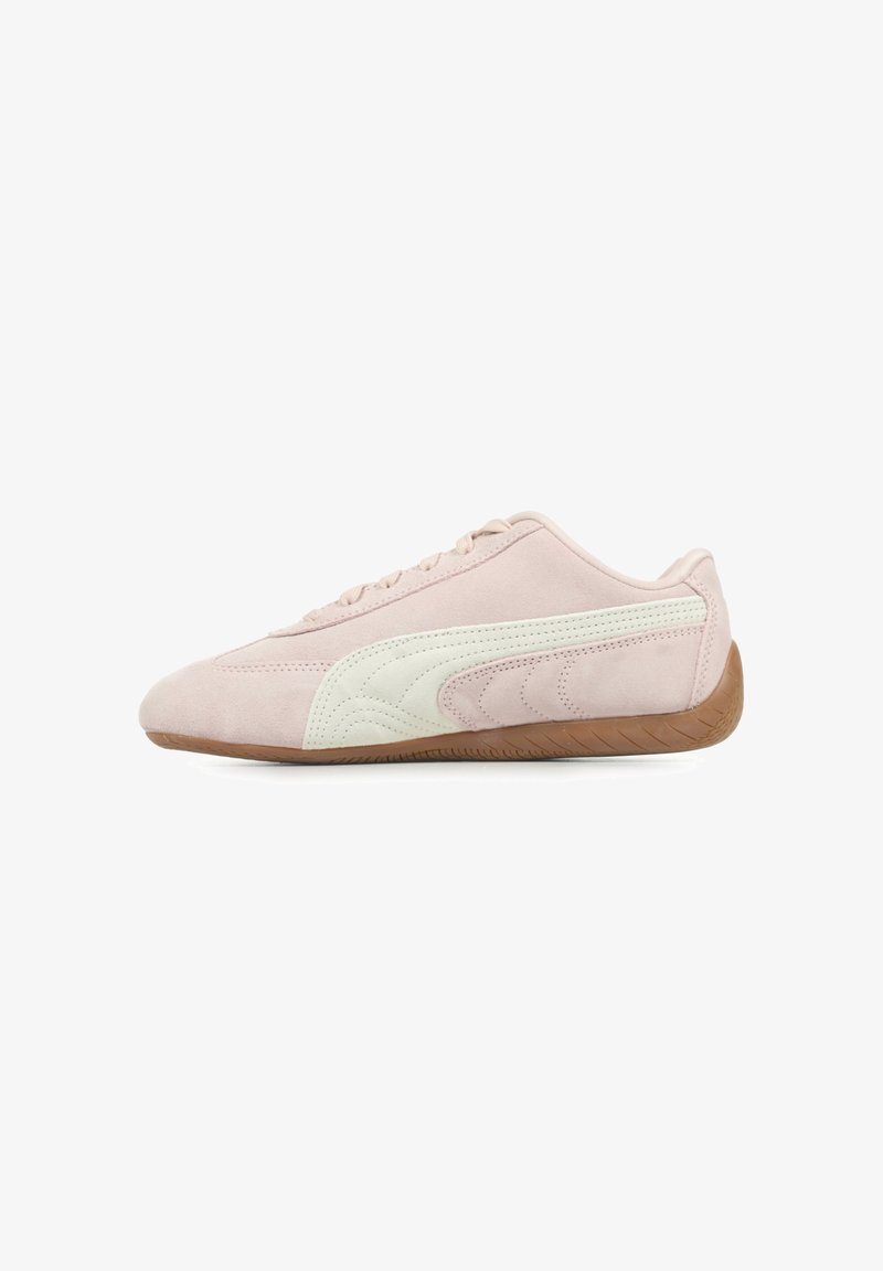 Sapatilhas de camurça rosa claro com detalhes em creme, apresentando uma sola de borracha texturizada e um design elegante e de perfil baixo.