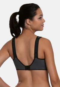 Sort sportsbh med tekstureret mesh-ryg, justerbare stropper og lukning med hægte. Glat stof med et moderne atletisk design.