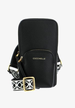 Black leather crossbody bag with a textured finish, gold hardware, front zip pocket, and a patterned adjustable strap in black and white.